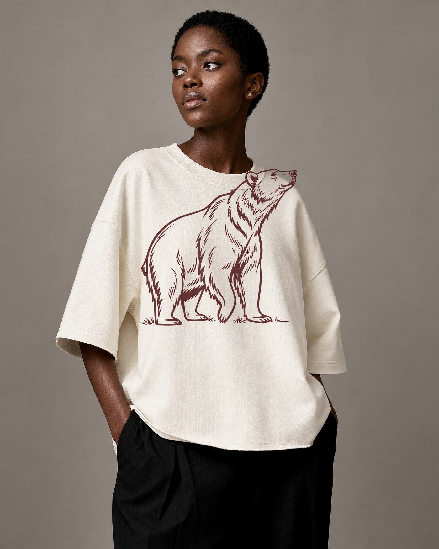 The Bear oversized tee, moon-white cotton with an oxblood bear illustration.