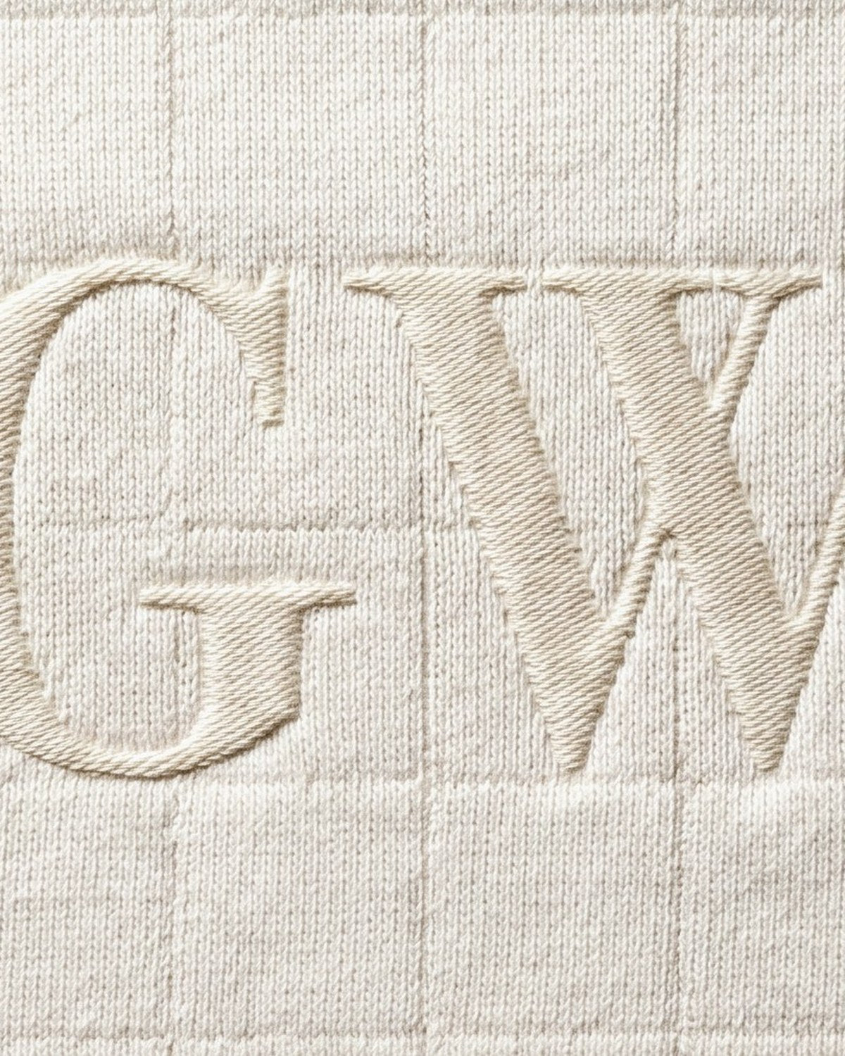 A moon-white knit with tonal GW satin-stitch embroidery — The Atelier.